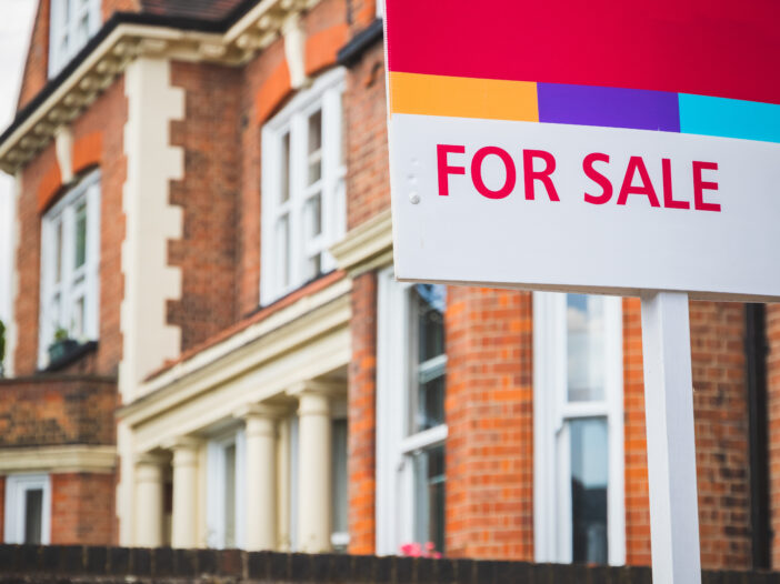 For Sale sign displayed outside a terraced house in Crouch End, London, UK